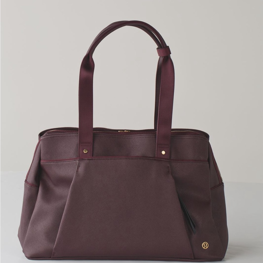 Lululemon OM the Day Burgundy bag with gold accents